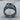 Abstract Merger Ring, oxidized silver finish, angled view on wood