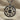 North Star Compass Pendant, oxidized finish, front view on stone