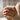 Person wearing the oxidized silver Virgo zodiac ring on finger while holding a ceramic coffee mug