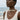Model wearing an elephant pendant necklace in a lifestyle beach setting showing everyday wear style