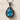 Filigree Teardrop Pendant, oxidized, studio product photo on stone surface