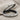 Two Loop Balance Ring, oxidized silver, angled side view on fabric