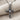 White Topaz Chevron Cross Pendant, oxidized, angled view on textured fabric