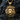Close-up of the intricately carved lion snake pendant in 14K gold vermeil resting on a dark reflective surface