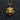 Close-up front view of gold tiger pendant on a chain highlighting the fierce expression over a dark textured surface