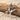 Bird Letter X Pendant, polished silver finish, angled on driftwood