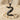 Swan Letter Z Pendant, black rhodium, angled view on sand