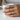 Three Stone Bypass Ring, worn on model hand holding a mug
