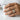Celtic Claddagh Ring, worn on model holding a white cup