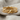 Macro close-up of the infinity knot ring showing detailed braided rope texture and smooth center cross on linen fabric