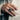Man wearing handcrafted oxidized silver Life and Death skull ring on finger against light beige jacket