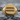 Round Equality Signet Ring, gold vermeil, front view on stone surface