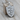 Dragon Shield Pendant, polished, front view resting on wood block