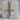 Three Nails Cross Pendant, rose gold, front view on concrete block