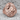 Facing Lovers Ring, rose gold finish, front view on stone surface