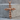Multi skull cross pendant, rose gold, front product view on concrete
