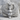 Winged Bastet Pendant, polished silver, front view resting on stone