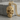 Floral Sugar Skull Pendant, gold vermeil, angled front view on stone