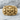 Fanged Demon Skull Ring, gold vermeil, front view on stone surface