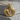 Lioness and cub medallion pendant, gold vermeil finish, front view on concrete block