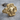 Pirate Ship Skull Ring, gold vermeil, angled front view on wood