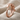 Coiled Alligator Ring, rose gold plated, angled front view on fabric