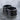 Two Finger Spell Storing Ring, black rhodium finish, angled view on wet stone