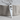 Hand Saw Pendant, polished silver, front view on wood block