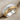 Two Row Cable Ring, two-tone, product photo on textured fabric