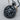 Scorpio Zodiac Medallion Pendant, black rhodium, angled view on wood surface with chain