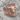 Bull Signet Ring, rose gold, angled view on rock surface