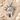 Statue of Liberty Pendant, polished silver, front view on sand