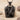 Doctor Coat Pendant, black rhodium, product photo on sand