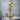 Skeleton hand anchor earring, gold vermeil, product photo on stone