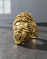 The all-gold version of the Justice Ring, showcasing the sculptural classical head with a blindfold and dollar sign gag.