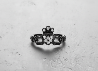 Front view of black rhodium plated silver Claddagh ring with sparkling stones in heart and crown