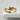 Clasping hands ring, gold vermeil finish, front view on stone surface