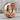 Cracked Hoop Earring, rose gold, product photo on rock surface