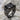 Brutalist onyx ring, black rhodium, three-quarter view on stone