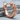 Cracked Brutalist Huggie Earring, rose gold, product photo on stone