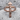 INRI Crucifix Ring, rose gold plated silver, front view on stone surface