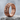 Coiled Dragon Scale Ring, rose gold, angled view on stone base