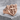 Cross Shield Ring, rose plated silver, angled view on stone surface