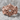 Lucii Crest Ring, rose gold, front view on stone surface