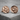 Forest Moon Wolf Cufflink, rose gold, front view on stone surface