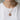 Model wearing the round two-tone Celtic Dara knot pendant necklace against white tshirt for daily wear