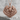 Eagle Wings Pendant, rose gold, front view on stone surface