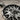 Close-up detail of hand-finished oxidized sterling silver grizzly bear pendant showcasing fine metal carving