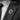 Detailed eagle lapel pin worn on charcoal grey suit jacket lapel for sophisticated men's styling