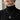 Model wearing handcrafted bat wax seal necklace with deep red enamel over a stylish black turtleneck